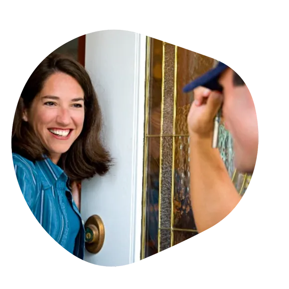 Woman Answering Front Door for Plumber